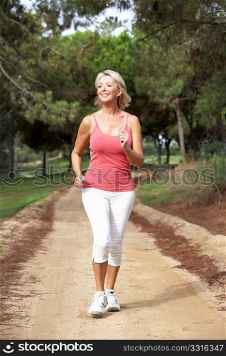 Senior woman running in park