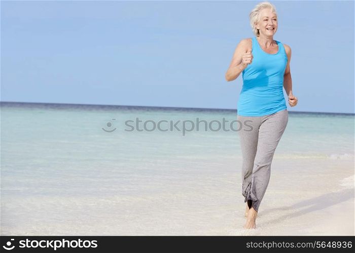 Senior Woman Running On Beautiful Beach