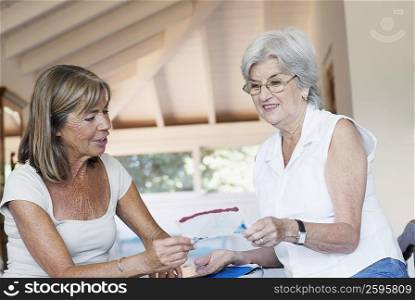 Senior woman showing a photograph to another senior woman