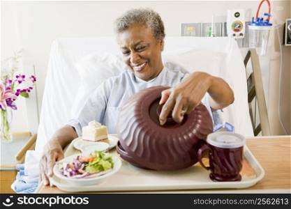 Senior Woman Sitting In Hospital Bed With A Tray Of Food
