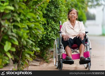 senior woman sitting in wheelchair at the park