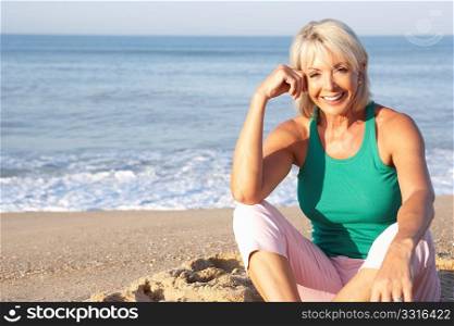 Senior woman sitting on beach relaxing