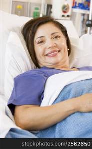 Senior Woman Smiling,Lying In Hospital Bed