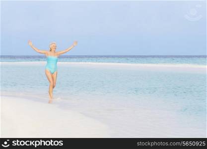 Senior Woman Splashing In Beautiful Tropical Sea