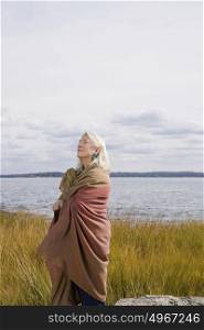 Senior woman standing near a lake