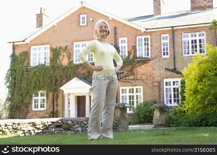 Senior Woman Standing Outside House