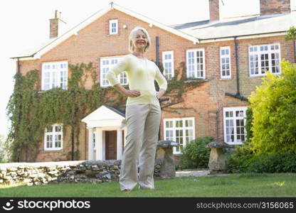 Senior Woman Standing Outside House