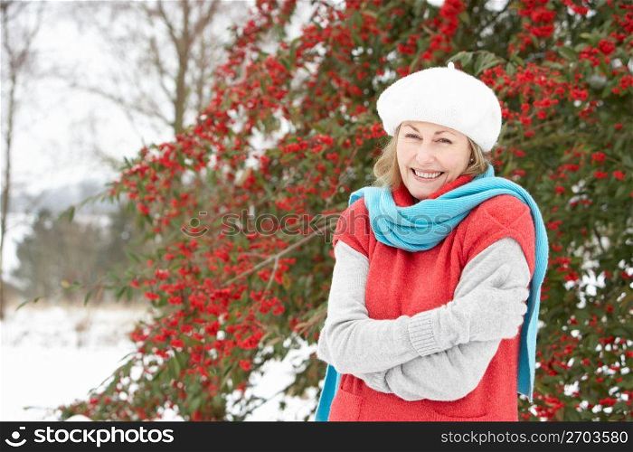 Senior Woman Standing Outside In Snowy Landscape