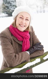 Senior Woman Standing Outside In Snowy Landscape