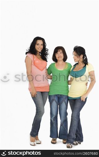 Senior woman standing with her two daughters and smiling