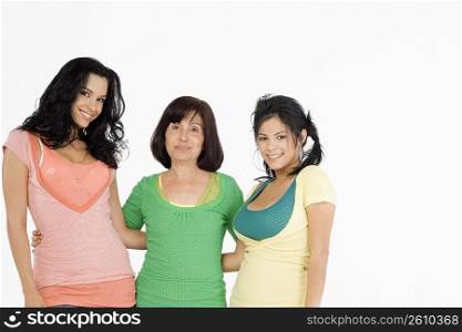 Senior woman standing with her two daughters and smiling