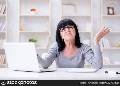 Senior woman struggling at computer