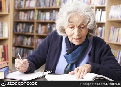 Senior Woman Studying In Library