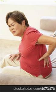 Senior Woman Suffering From Back Pain At Home