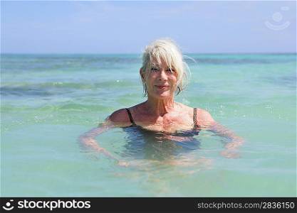 Senior woman swimming in the sea