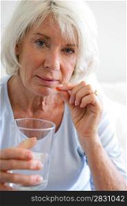 Senior woman taking her medication