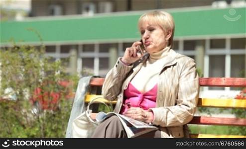 Senior woman talking on cellphone outdoors