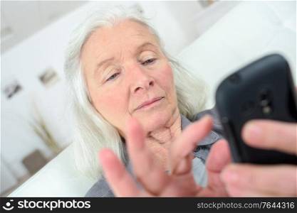 senior woman texting on her new smartphone