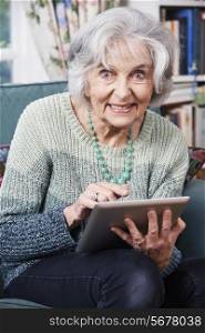 Senior Woman Using Digital Tablet At Home