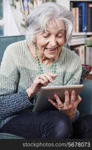 Senior Woman Using Digital Tablet At Home