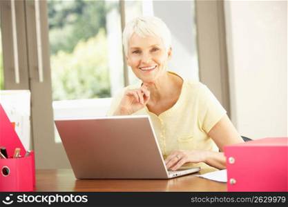 Senior Woman Using Laptop At Home