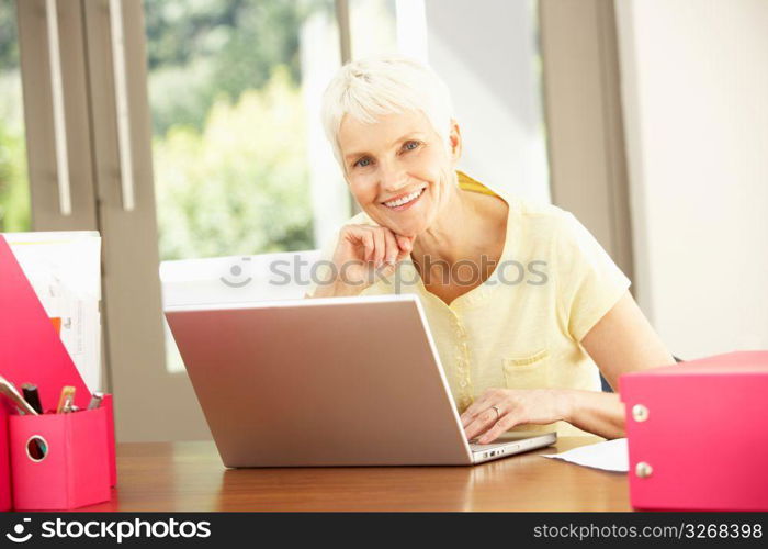 Senior Woman Using Laptop At Home