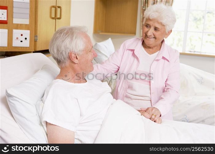 Senior Woman Visiting Her Husband In Hospital