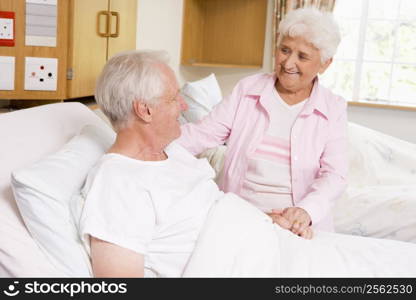 Senior Woman Visiting Her Husband In Hospital