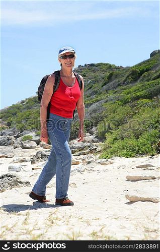 Senior woman walking by the coast