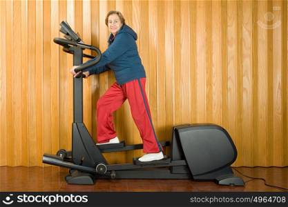 Senior woman walking on a treadmill