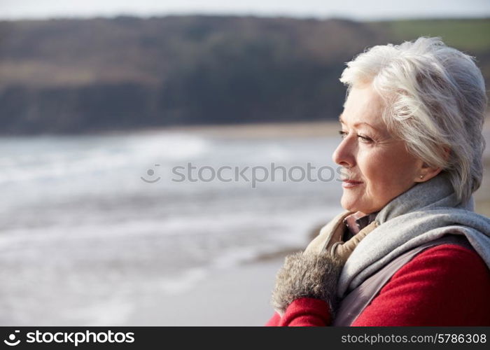 Senior Woman Walking On Winter Beach