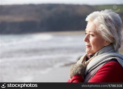 Senior Woman Walking On Winter Beach