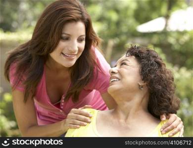 Senior Woman With Adult Daughter In Garden