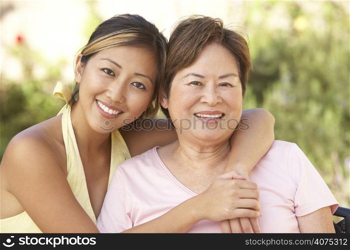 Senior Woman With Adult Daughter In Garden Together