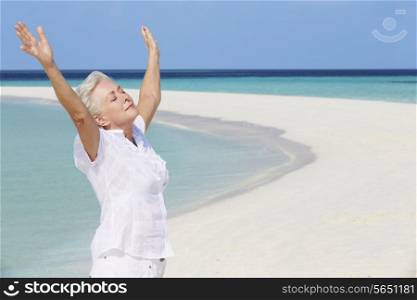 Senior Woman With Arms Outstretched On Beautiful Beach