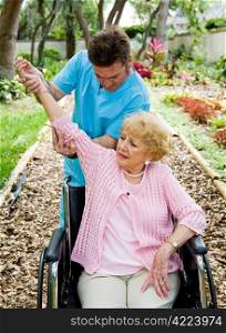 Senior woman with arthritis in her shoulder receives physical therapy in outdoor setting.