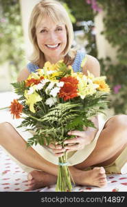 Senior Woman With Bunch Of Flowers