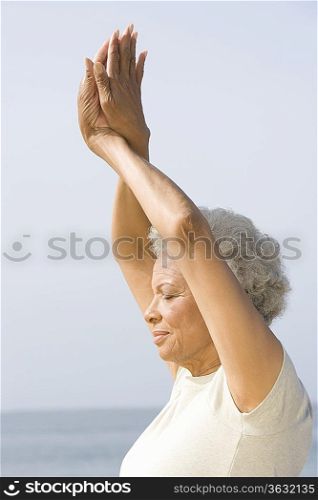 Senior woman with eyes closed in yoga pose