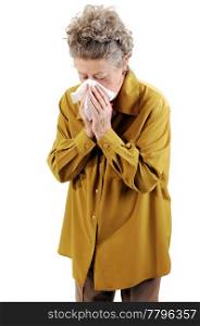 Senior woman with gray hair and an dark yellow jacket blowing her noseShe is sick with a cold. On white background.