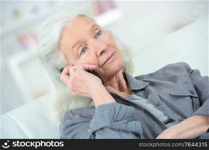 senior woman with phone feel unwell