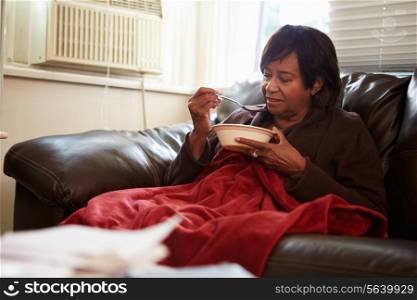 Senior Woman With Poor Diet Keeping Warm Under Blanket
