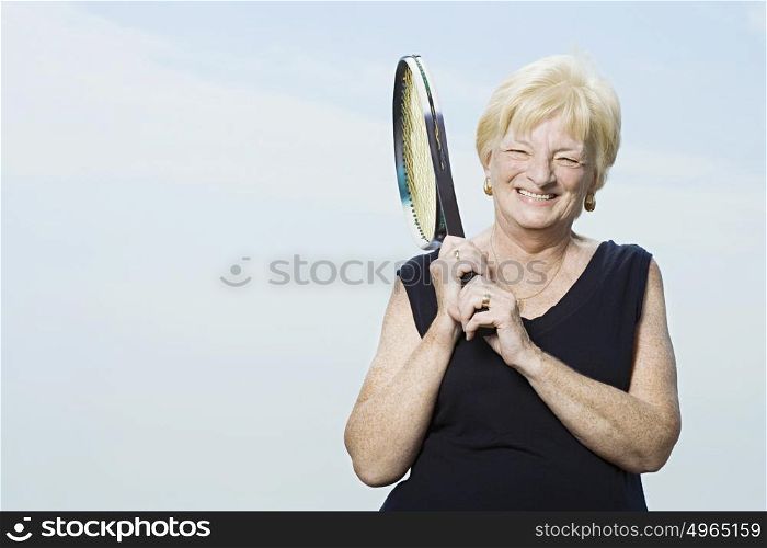 Senior woman with tennis racket