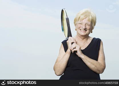 Senior woman with tennis racket