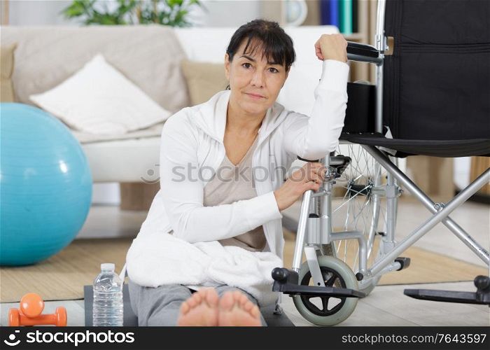 senior woman with trainer doing fitness sport in gym