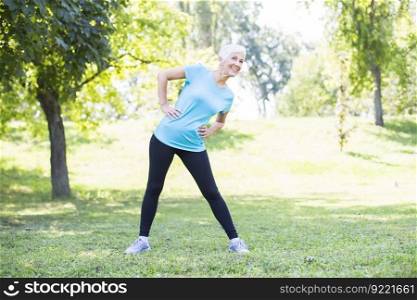Senior woman workout in the park. Maintaining health of elderly lady in retirement concept.