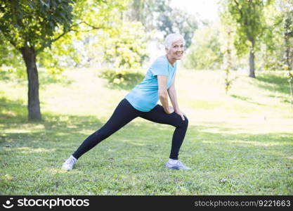 Senior woman workout in the park. Maintaining health of elderly lady in retirement concept.