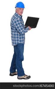 Senior worker holding laptop