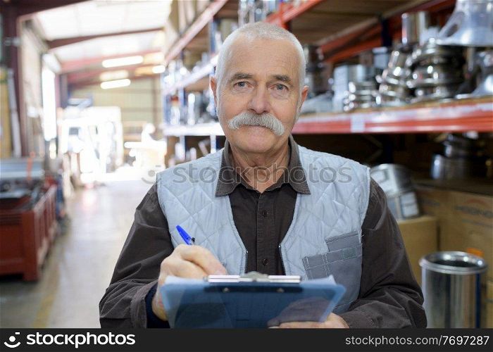 senior worker in a warehouse in a factory