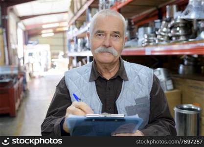 senior worker in a warehouse in a factory
