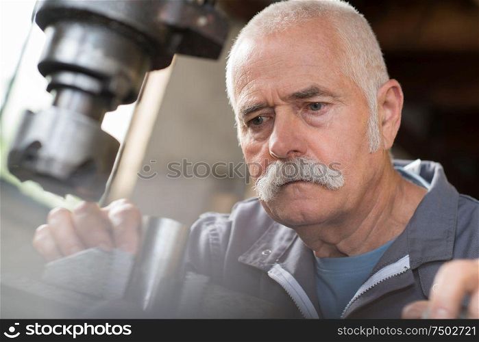 senior worker portrait in metalwork factory